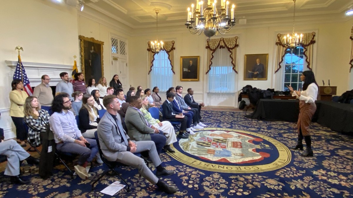 People gathered in conversation, representing civic life and social connection