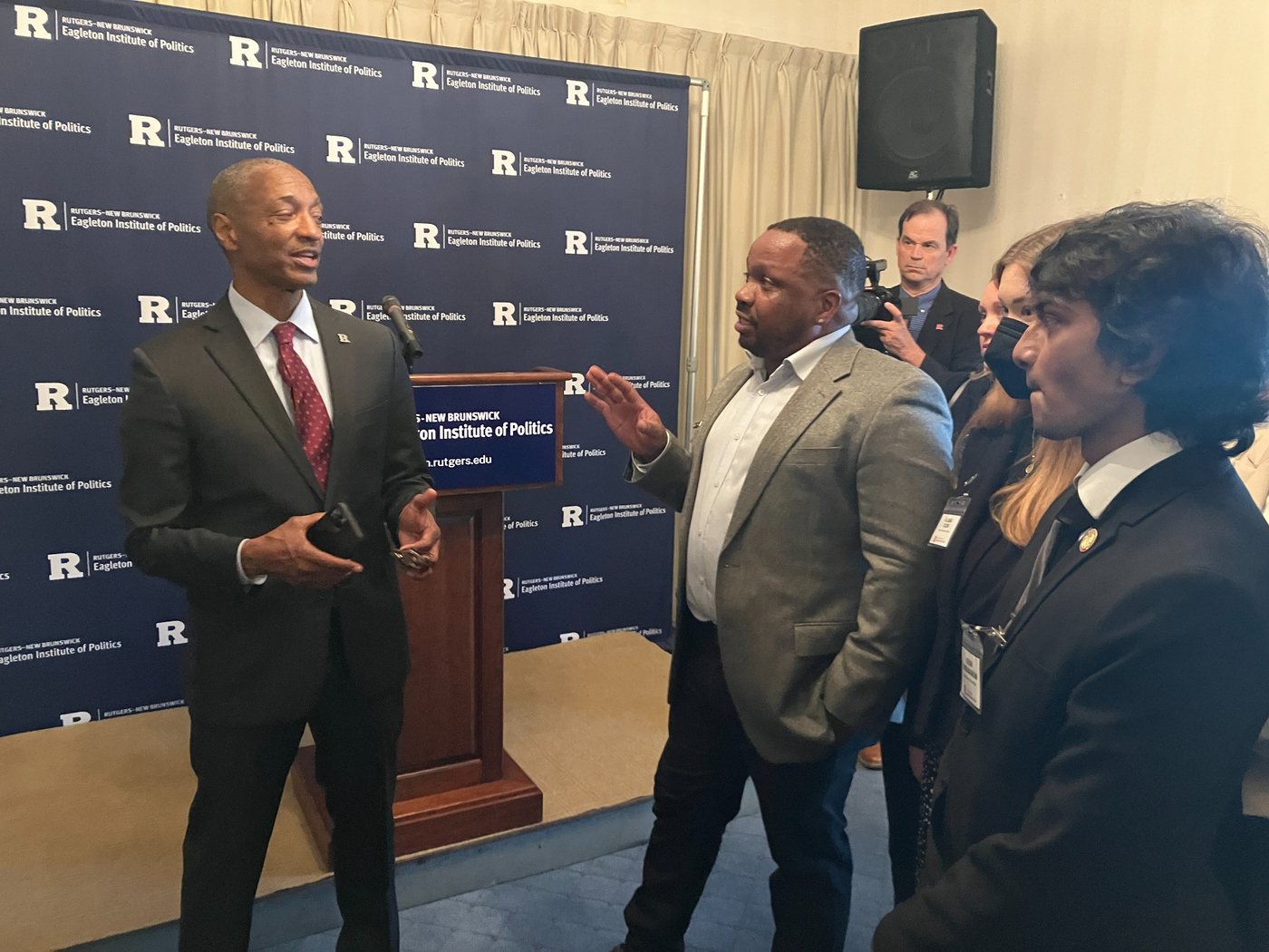 People in conversation at an institutional event